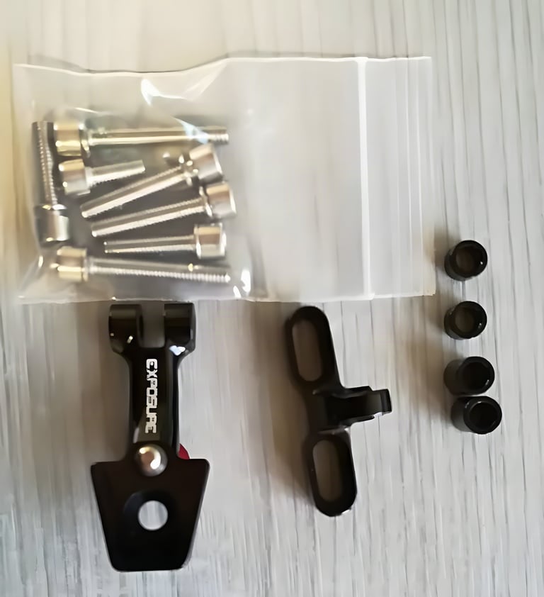 Contents of the USE Exposure Stem Fit Bracket bag: black alloy bracket parts, a bag of bolts and four washers.