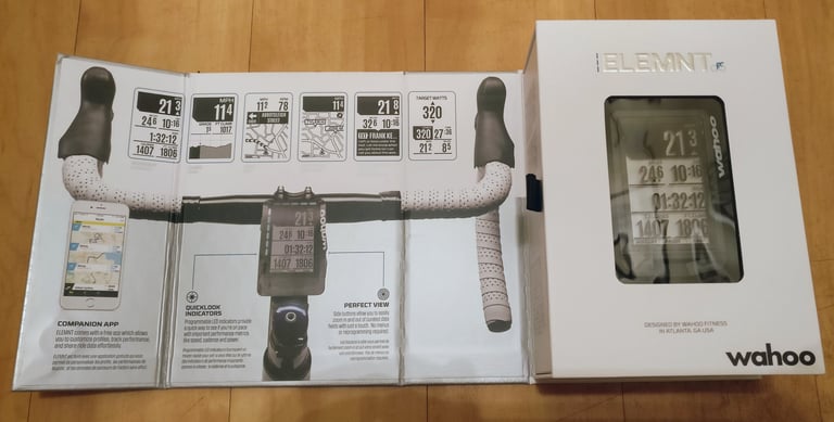Wahoo ELEMNT box opened flat, showing the fold-out guide to the companion app and LED indicators.