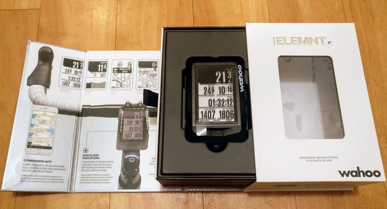 Opened Wahoo ELEMNT box with the GPS bike computer sitting in its tray beside the fold-out leaflet.
