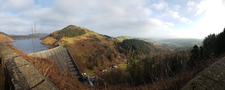 Panoramic view over the Clywedog Reservoir dam and forested hills near Llanidloes, Mid-Wales.
