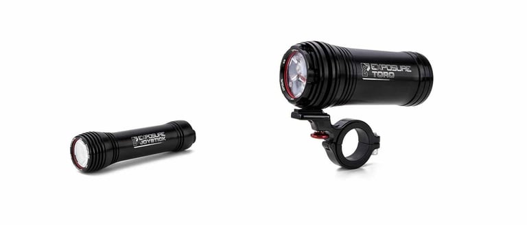 Exposure Joystick helmet light and Exposure Toro handlebar light in black, side by side on a white background.