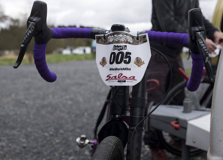 Dirty Reiver 2017 number plate 005 on the handlebars of a Cannondale Slate, with purple bar tape and SRAM Force levers.