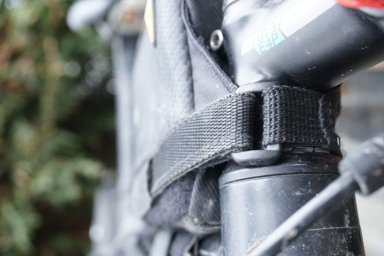 Topeak Fuel Tank steerer strap looped around the base of the stem, holding the bag in place.