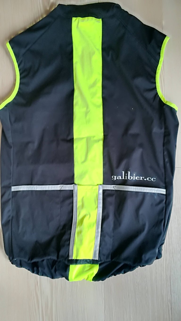 Galibier Ultimate Foul Weather Gilet laid flat, rear view, with yellow centre panel and reflective pocket trim.