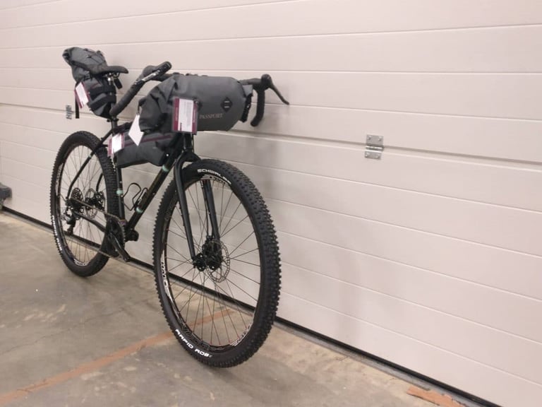 Front view of the Light Blue Darwin One By MT with Passport handlebar roll, frame pack and 2.25in Schwalbe tyres.