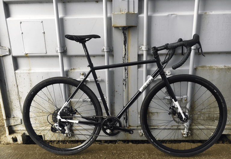 Slim steel tubes, straight-bladed fork and Schwalbe G-One tyres on the black All-City Macho Man test bike.