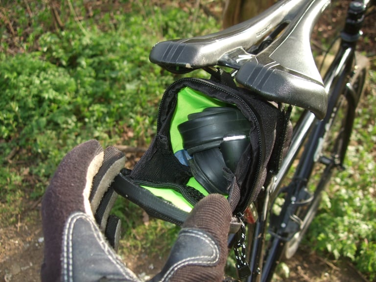 Open Passport Frequent Flyer seat pack showing the bright green liner and a spare inner tube inside.