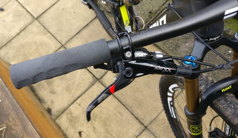ODI F-1 Vapor grip fitted to a mountain bike's flat bar, with a SRAM brake lever and shifter beside it.