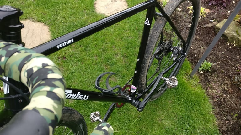 Top-down view of the Fearless Vulture's black frame with understated Vulture and Fearless graphics, on a lawn.