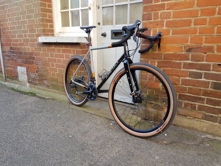 Front three-quarter view of the Bombtrack Audax showing its carbon fork and WTB tan-wall tyre.