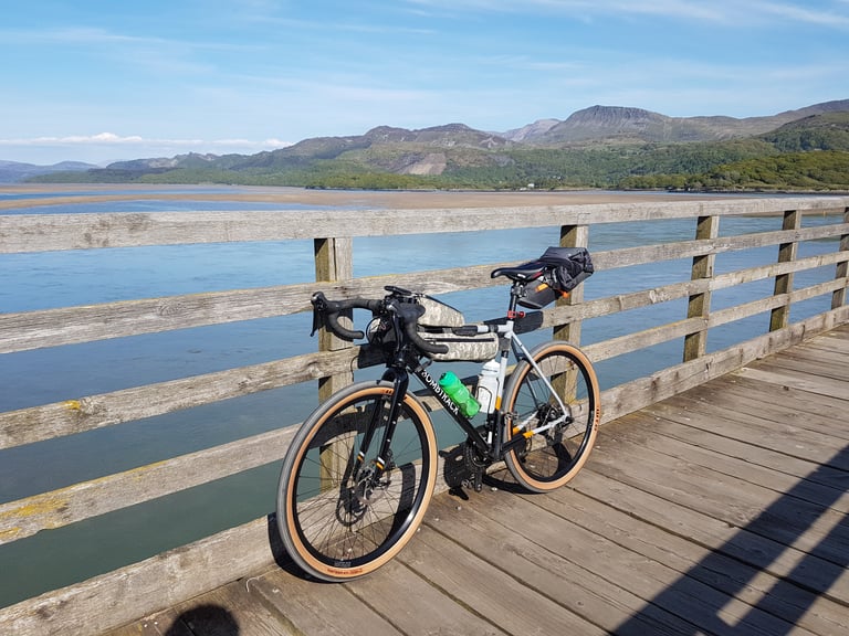 Bombtrack Audax with bikepacking bags on a wooden bridge over an estuary on the Bryan Chapman Memorial audax.