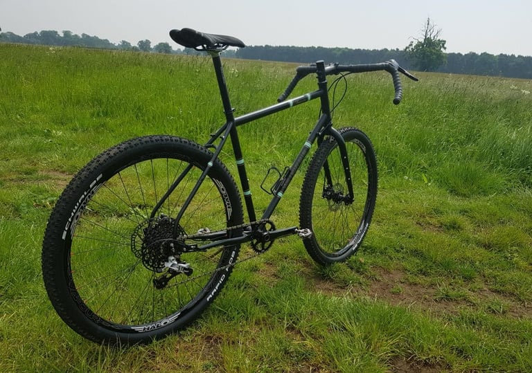 Rear three-quarter view of the Darwin One By MT showing its 1x11 SRAM Rival drivetrain and wide, knobbly tyres.