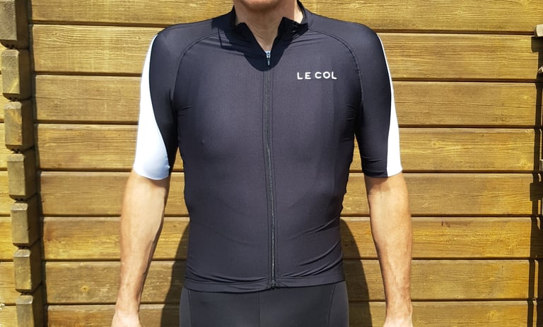 Black Le Col HC Clima jersey from the front, with white gripper panels on the sleeves and lettering on the chest.