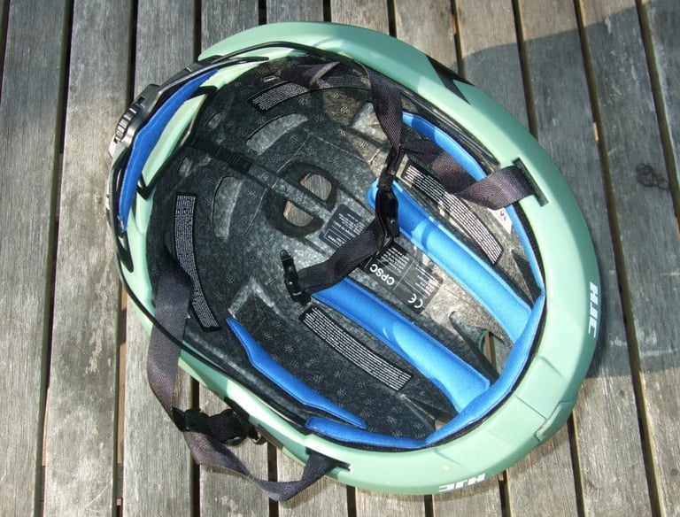 Inside of the HJC Furion helmet, with blue padding, foam liner and retention straps.