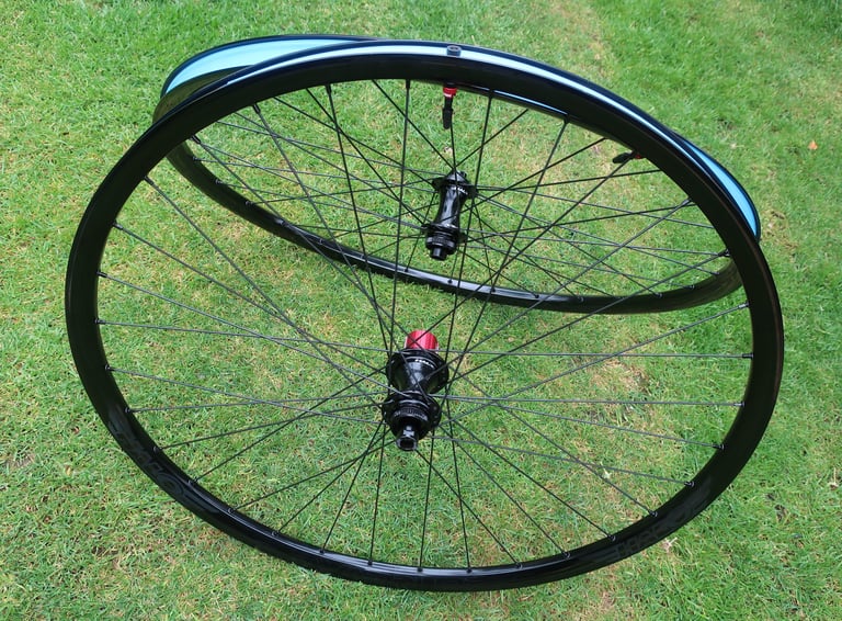 Halo Vapour GXC wheelset on grass, black rims with blue rim tape, spokes and black hubs.