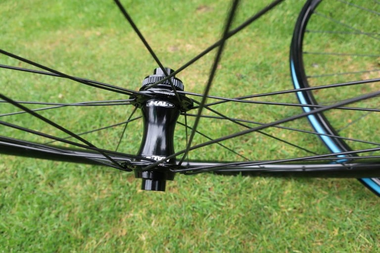 Halo Vapour GXC front hub with 12mm thru-axle end caps, seen from the side among the spokes.