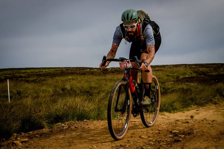 Paul Errington, number 052, rides a gravel bike over a rough moorland track at Yorkshire True Grit 2018.