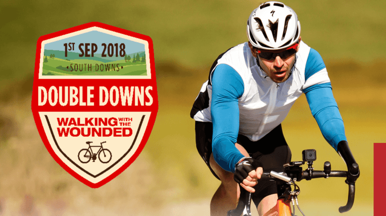 Walking With The Wounded Double Downs badge dated 1st Sep 2018 beside a rider in a white helmet and blue sleeves.