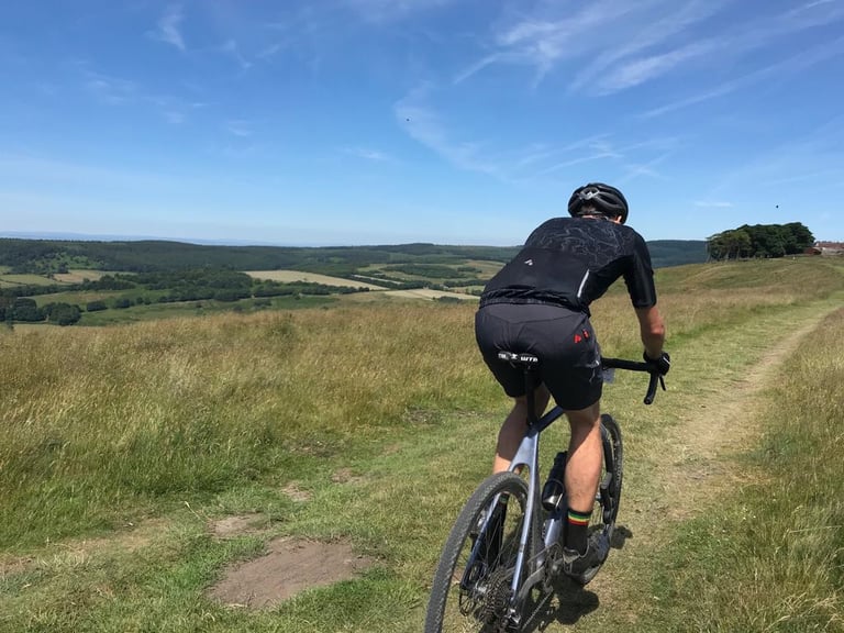 Rider on the Lauf True Grit climbs a grassy moorland track above farmland during Yorkshire True Grit's Stampede.