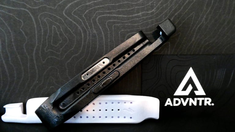 Specialized EMT MTB tyre levers, the black one with a metal insert lying over the white one, clip end uppermost.