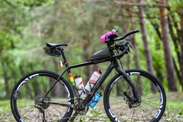 David Markman's black Salsa Warbird with Lauf Grit fork, aero bars, ENVE wheels and frame bags for Dirty Kanza.