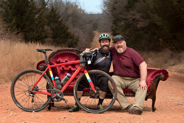 Paul Errington and Salsa's Kid on a red chaise longue on a red dirt road at the Land Run, his Warbird in front.