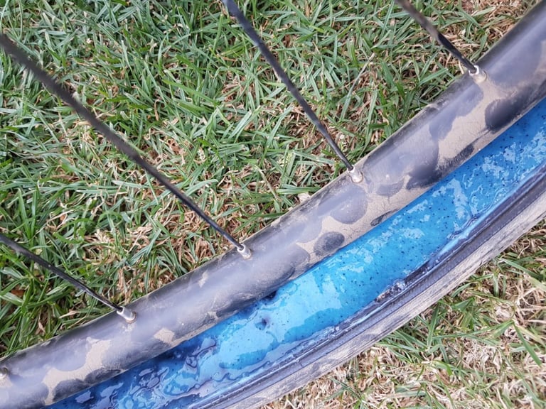 Blue Finish Line sealant with Kevlar fibres pooled in the rim bed of a tubeless wheel after the tyre was removed.