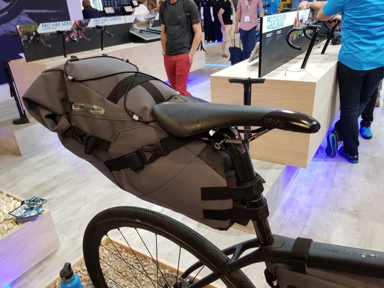 PRO Discover 15 litre seat pack strapped to the saddle rails and seatpost of a Trek Checkpoint at Eurobike.