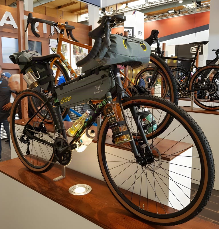 Marin Four Corners bikepacking rig with Apidura Backcountry bags and a bottle of whiskey on the fork at Eurobike.