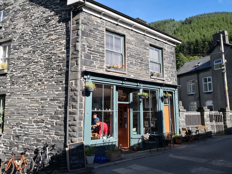 Idris Stores in Corris, a slate-built shop and cafe where Bike Corris rides start, with bikes parked outside.