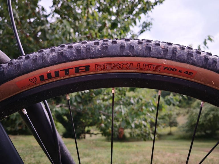 Sidewall of a WTB Resolute 700 x 42 tyre on a gravel bike wheel, with the tan wall and red label.