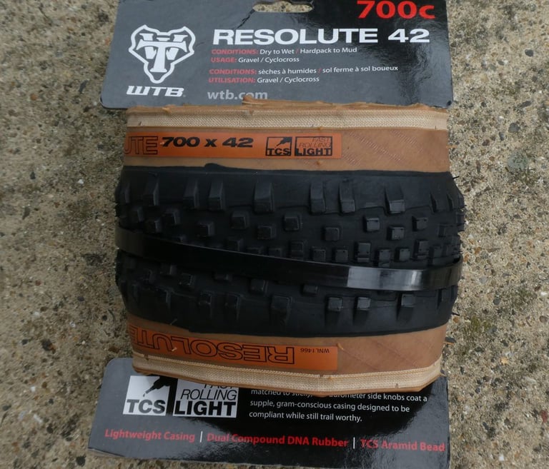 WTB Resolute 700c x 42 TCS Light tyre, still folded in its retail packaging, on a paved surface.