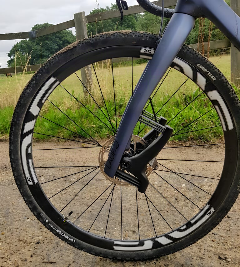 Close-up of the Lauf Grit SL leaf-spring fork with an ENVE XC wheel and Goodyear Connector tyre.