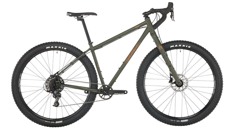 Salsa Fargo Apex 1 in olive green with drop bars and 29 x 2.6 Maxxis tyres, side view.