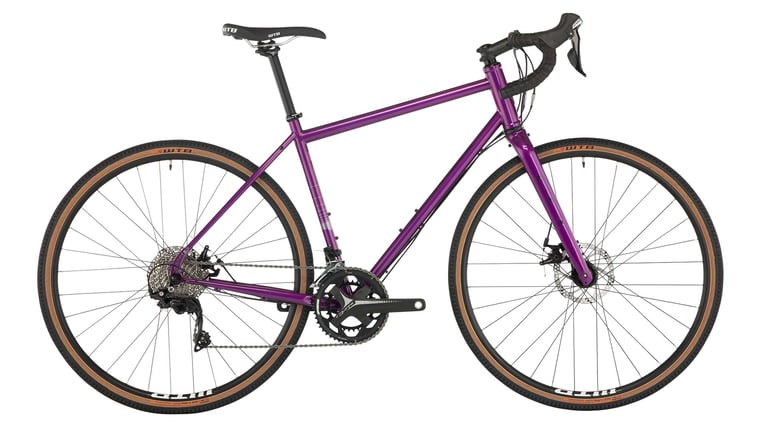 Salsa Vaya 105 steel touring bike in purple with tan-wall tyres and Shimano 105 groupset, side view.