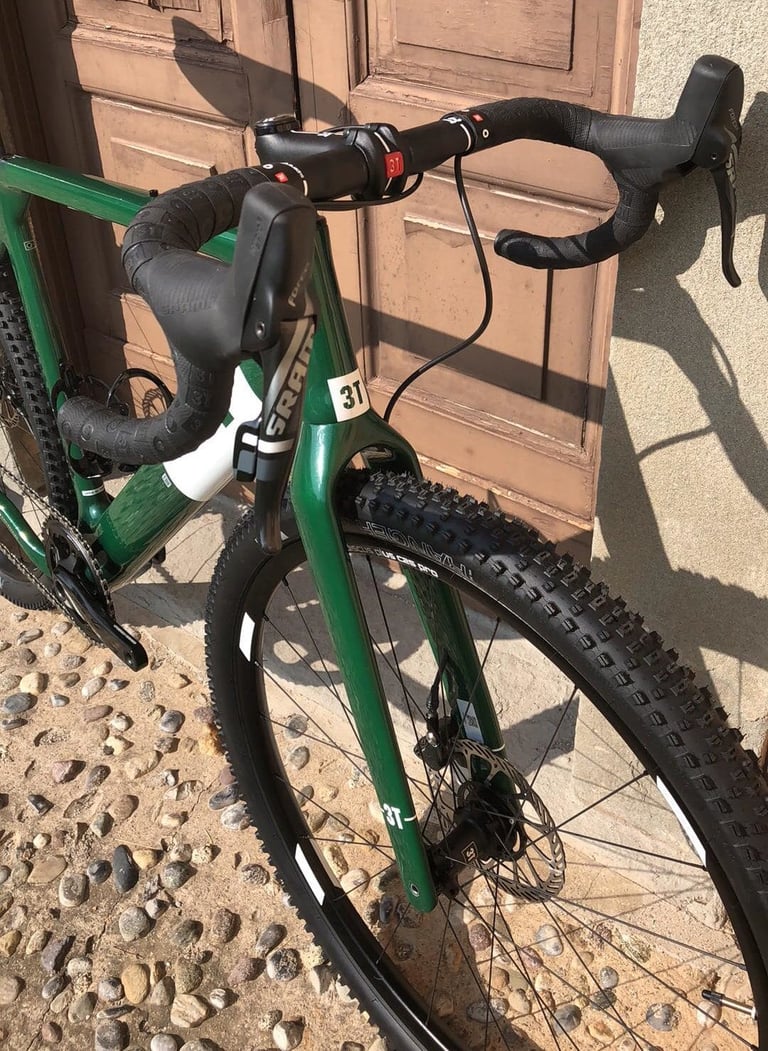 Cockpit of the green 3T Exploro Flatmount, with SRAM shifters, black bar tape and the new Fango fork.
