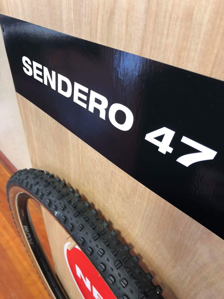 Knobbly tread of the WTB Sendero 47 650b tyre below its display board sign.