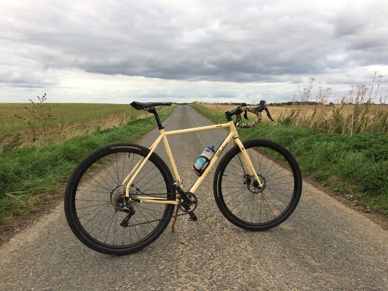 Fearless Vulture gravel bike on Halo Vapour GXC wheels on a quiet tarmac lane between fields.