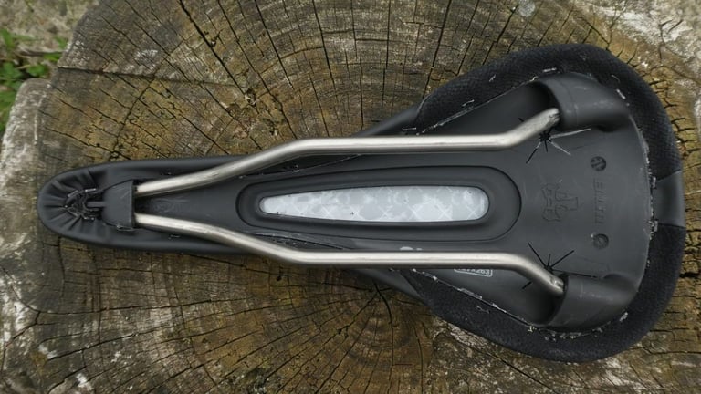 Underside of the WTB SL8 saddle showing the titanium rails and the central cut-out in the base.