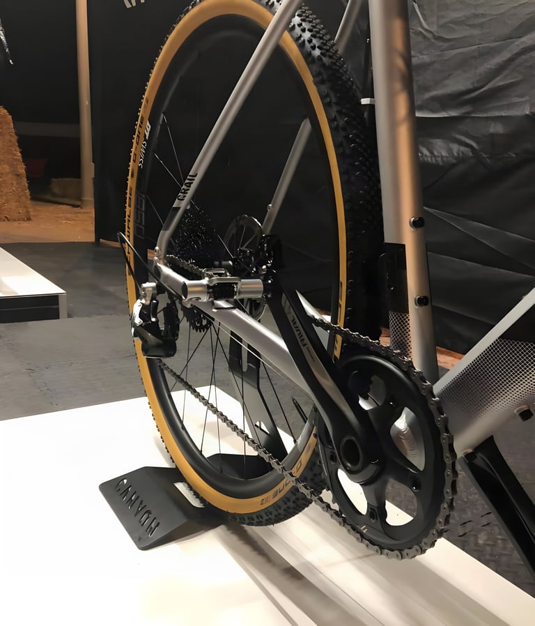 Rear of the Canyon Grail AL show bike with SRAM Rival 1x chainset, rear derailleur and a tan-wall tyre.