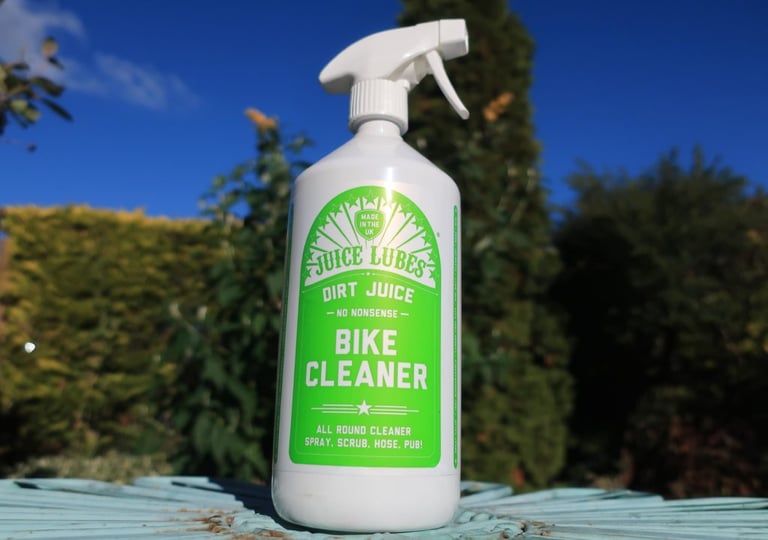 Juice Lubes Dirt Juice Bike Cleaner in a one-litre trigger spray bottle on a garden table.