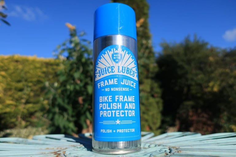 Juice Lubes Frame Juice bike frame polish and protector aerosol with a blue cap.