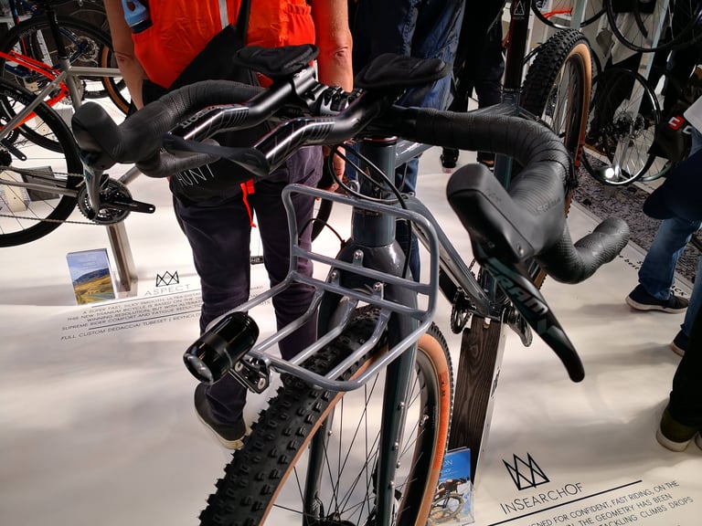 Prototype front rack and dynamo light on the grey Mason ISO, seen over the drop bars at the Cycle Show.