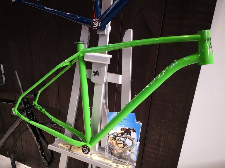 Bare green Mason ISO steel frame on a display stand, with its tubing and frame mounts visible.
