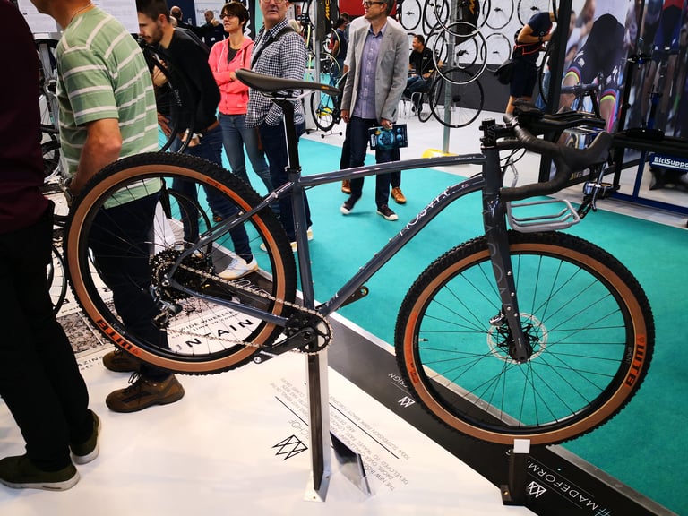 Grey Mason ISO with tan-wall tyres and a prototype front rack on display at the Cycle Show, side view.