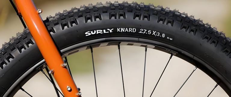 Surly Knard 27.5 x 3.0 plus tyre fitted to the 2019 ECR, beside the orange fork leg.