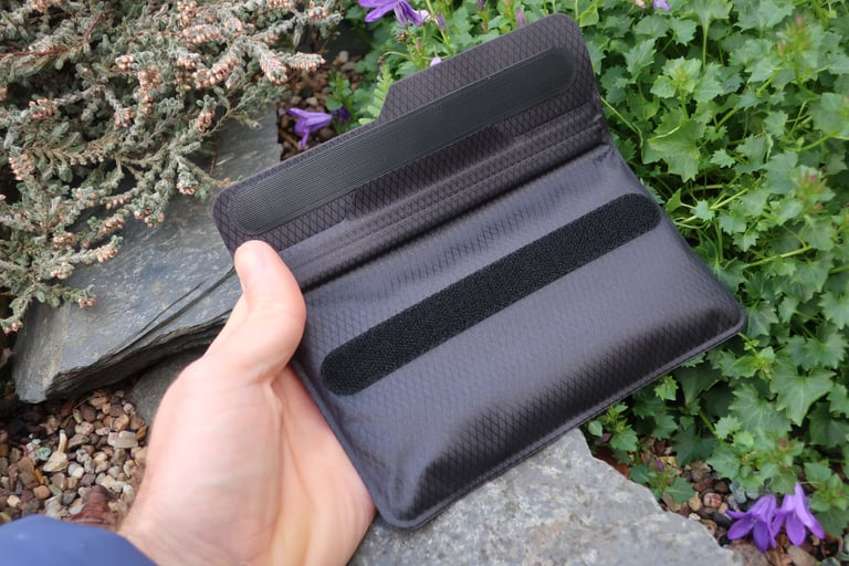 Underside of the Fickaskåp phone wallet with the storm flap open, showing the two strips of velcro.