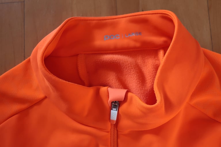 Collar and zip garage of the orange POC AVIP Ceramic Thermal Jersey, with brushed fleece lining inside.