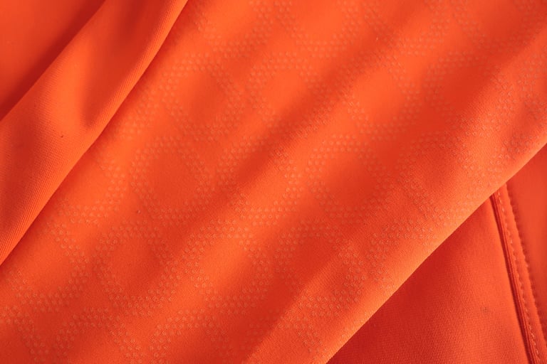 Close-up of the POC AVIP jersey sleeve showing the raised dimple pattern of the ceramic and Vectran panel.