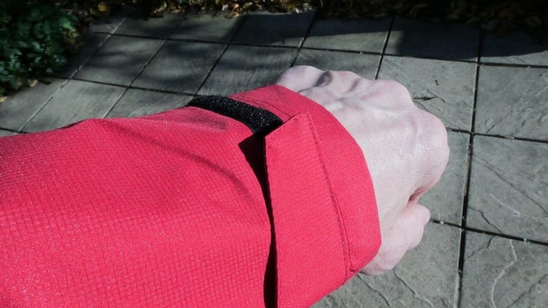 Velcro cuff tab on the sleeve of the Altura Nightvision Thunderstorm Jacket, fastened around a wrist.